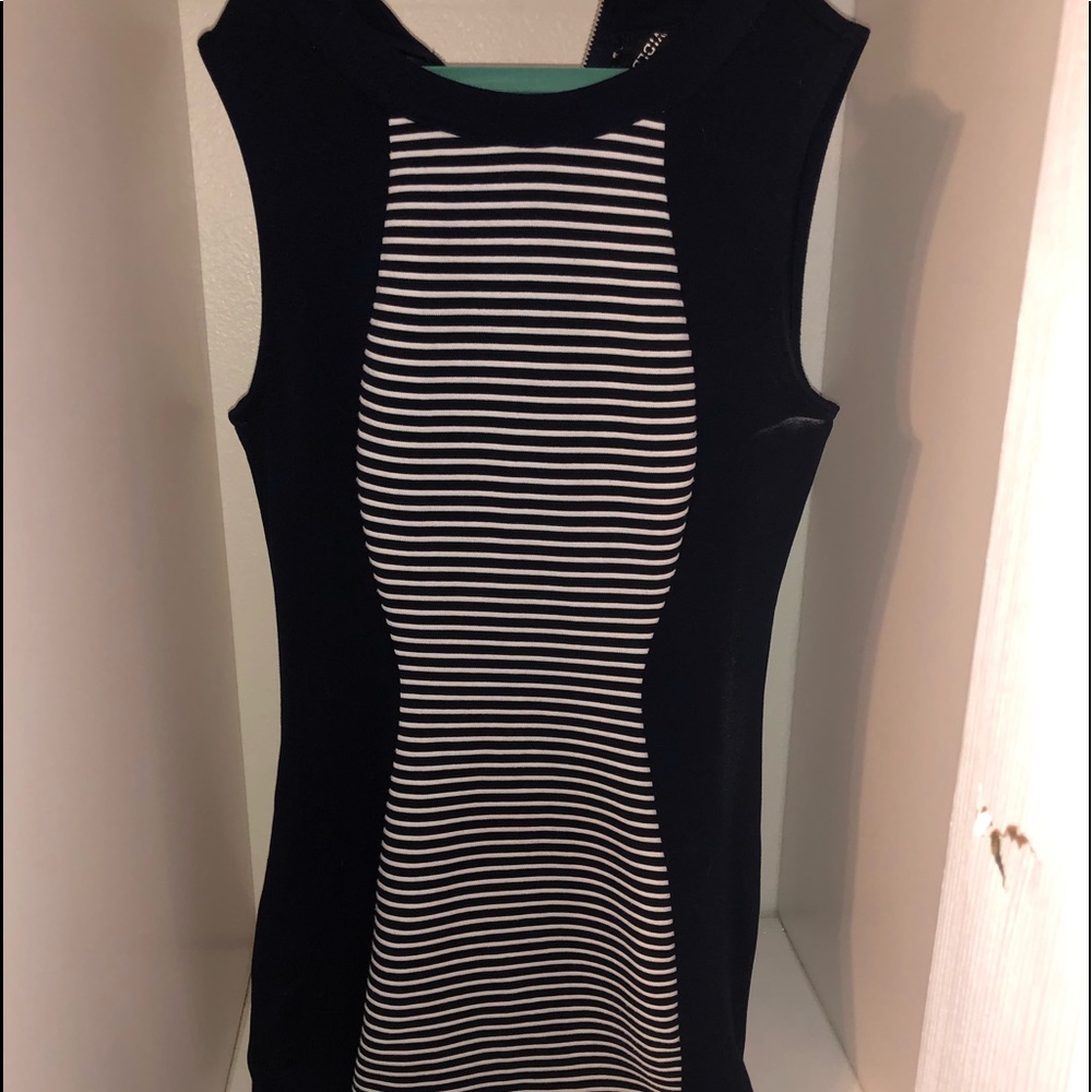 A fit, dark blue dress with stripes in the middle.